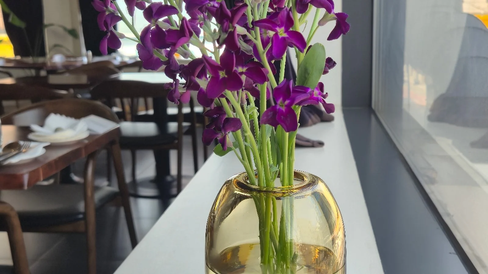 Purple seasonal flowers at Mahina Vegan Table