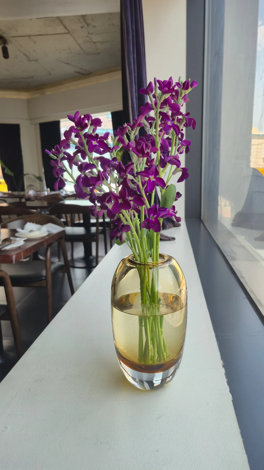 Purple seasonal flowers at Mahina Vegan Table