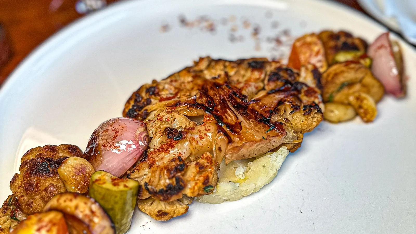 Mahina Vegan Table Cauliflower Steak with grilled cauliflower, orange and pickles