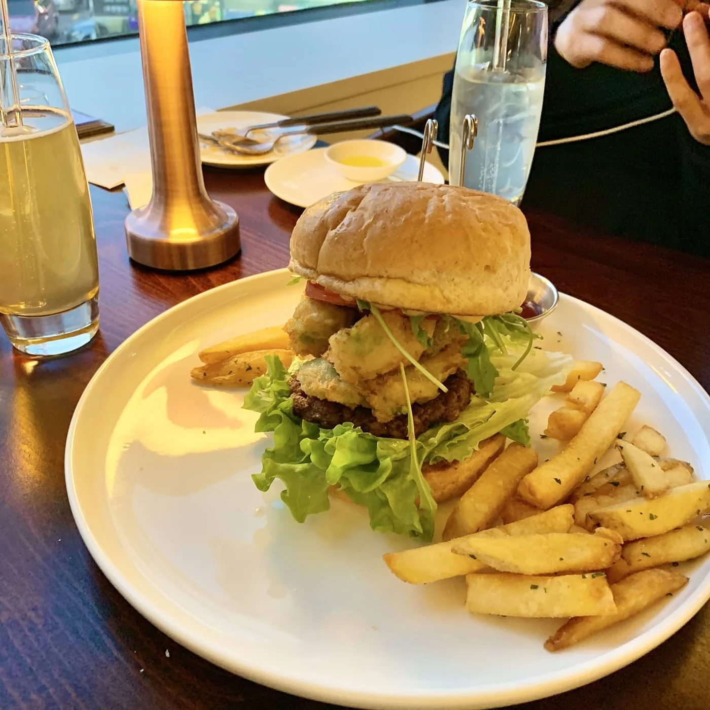Mahina Vegan Table Fried Avocado Burger served with French fries