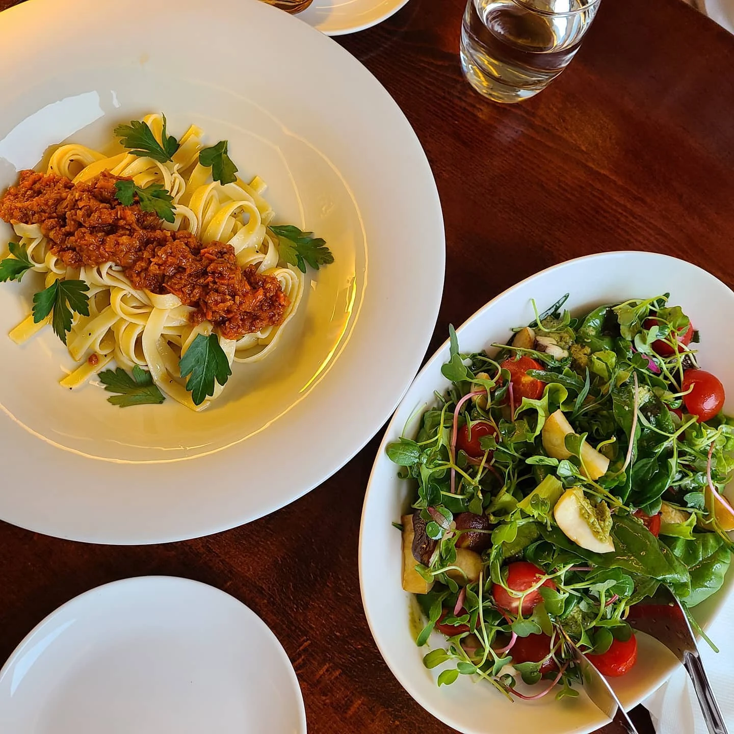 A Mahina Vegan Table setting with Bolognese Pasta and salad