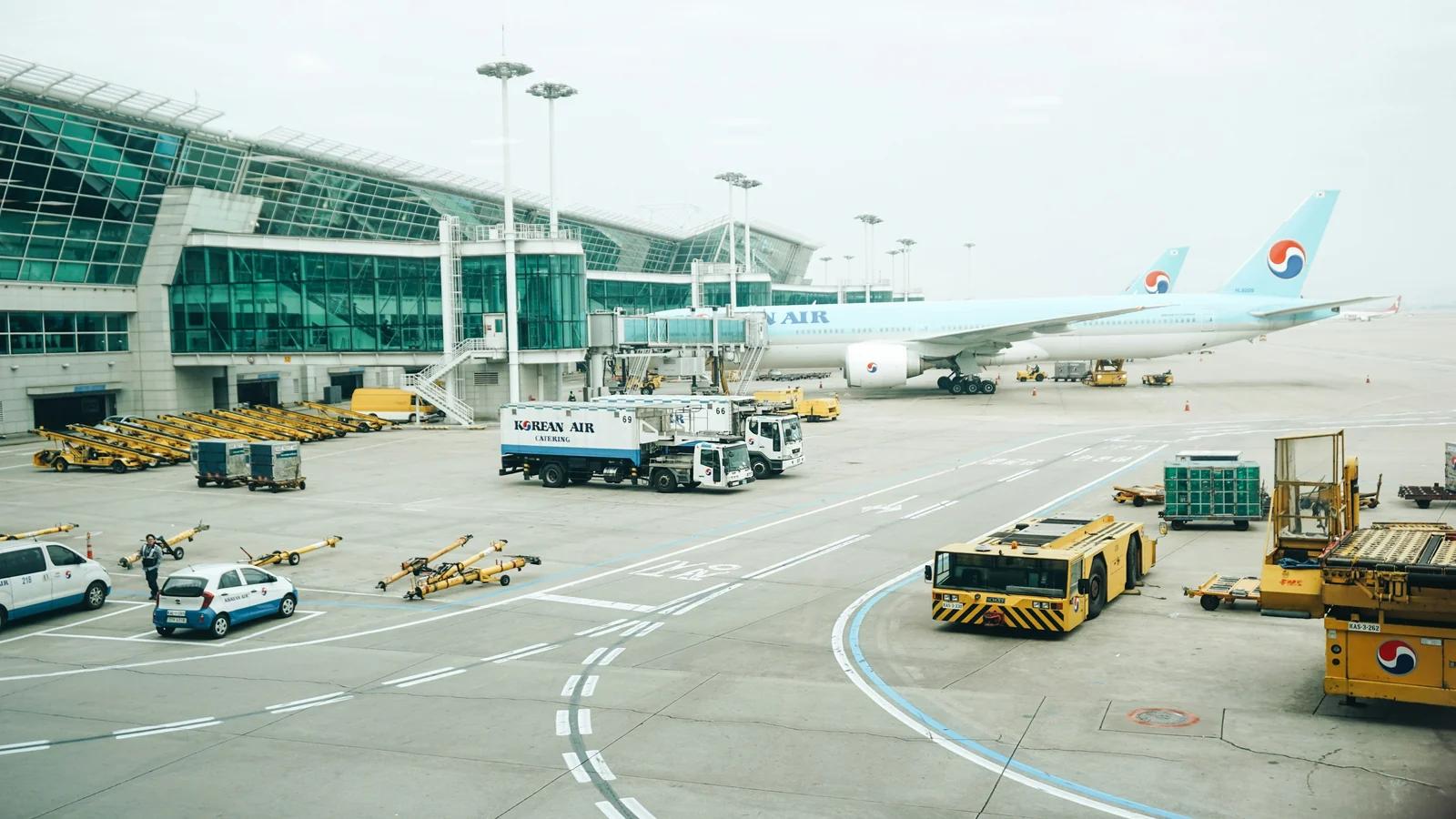 Passenger aircraft and ground vehicles on the apron at Incheon International Airport