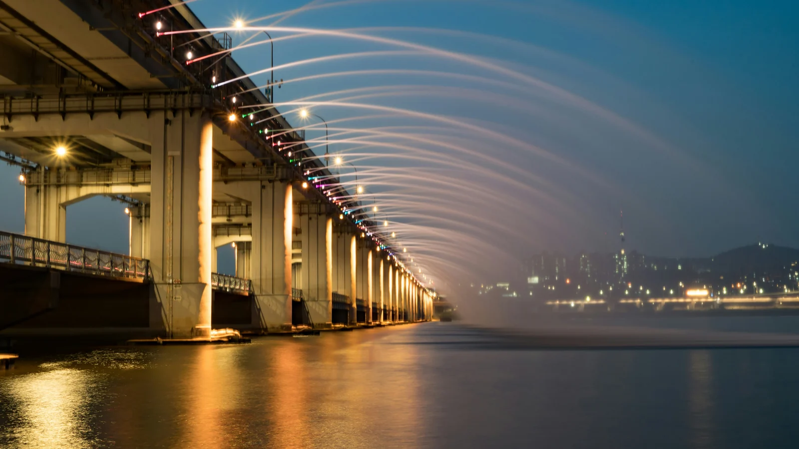 The Han River in Seoul at night with an illuminated bridge
