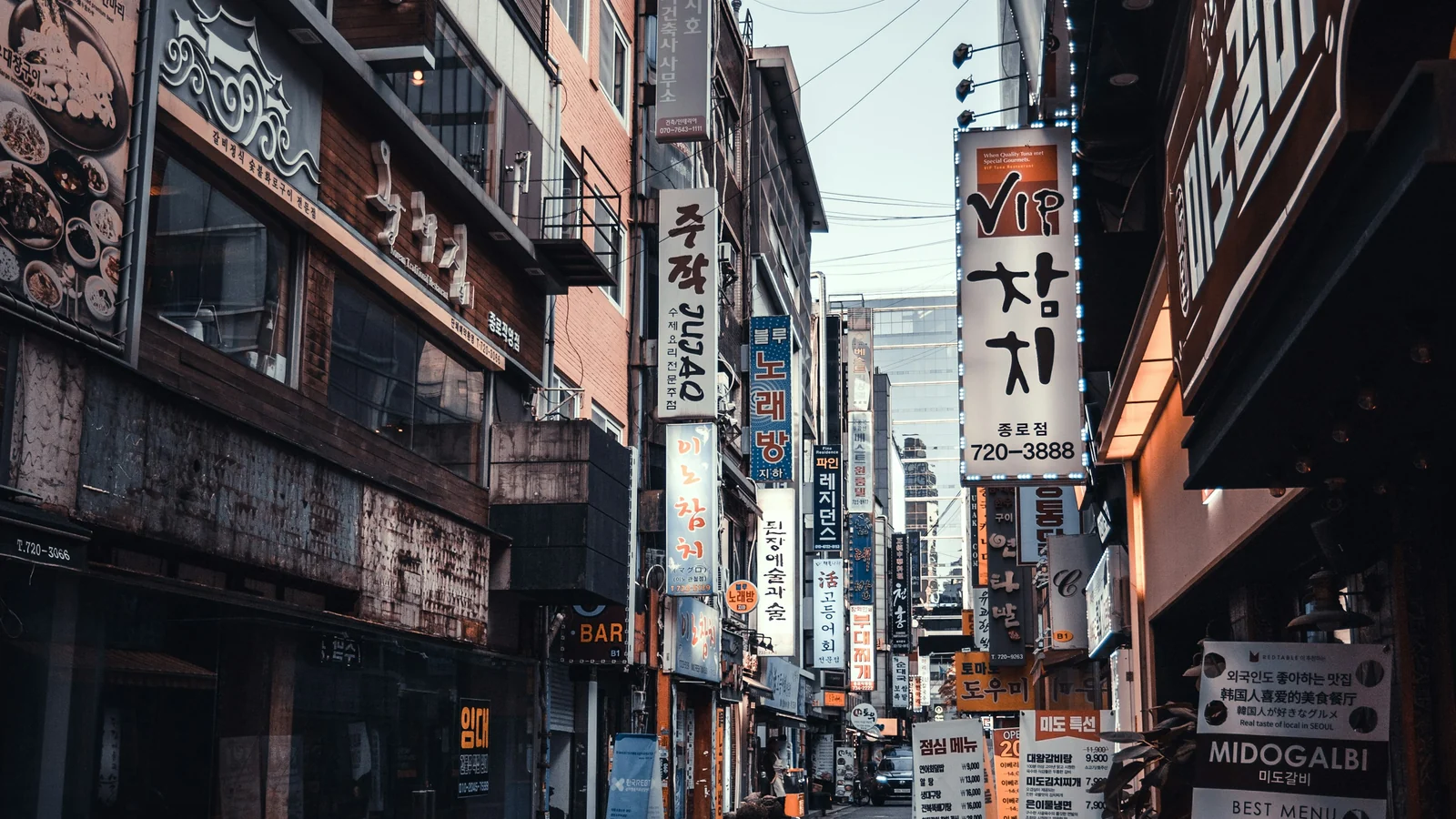 Pedestrians on a small Seoul street during the day
