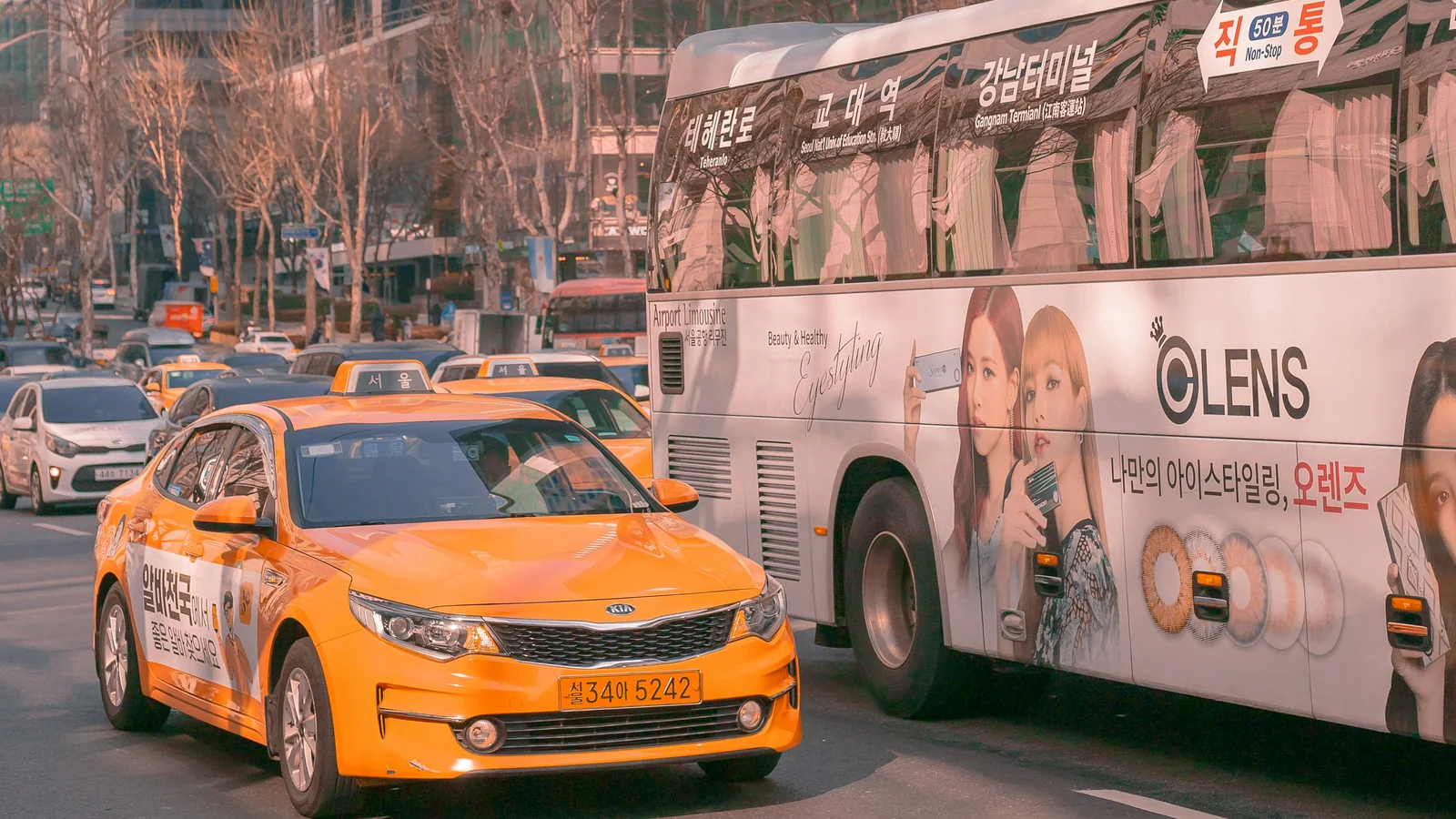 Taxis and buses travelling on a central Seoul road