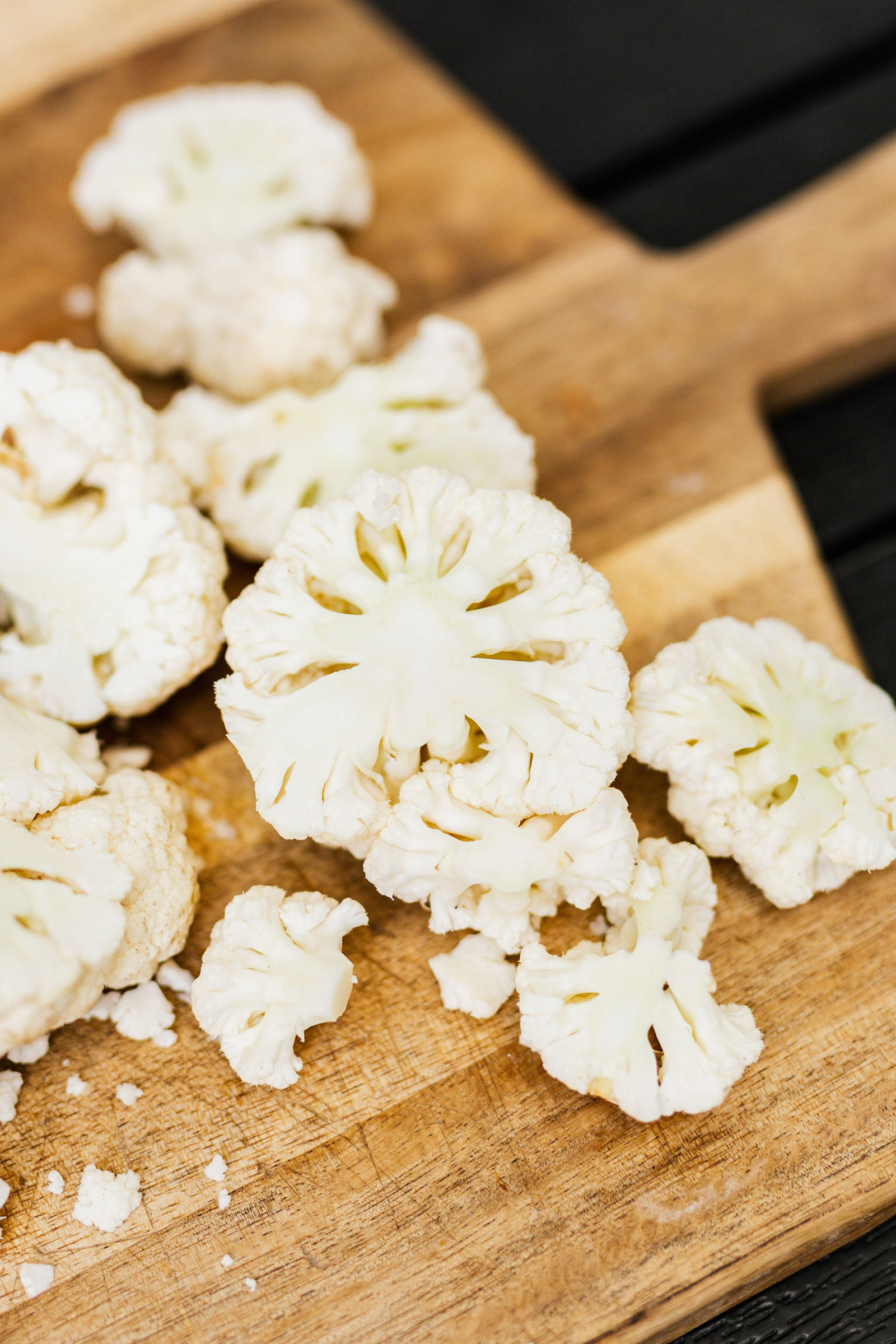 A cross-section of fresh cauliflower on a chopping board