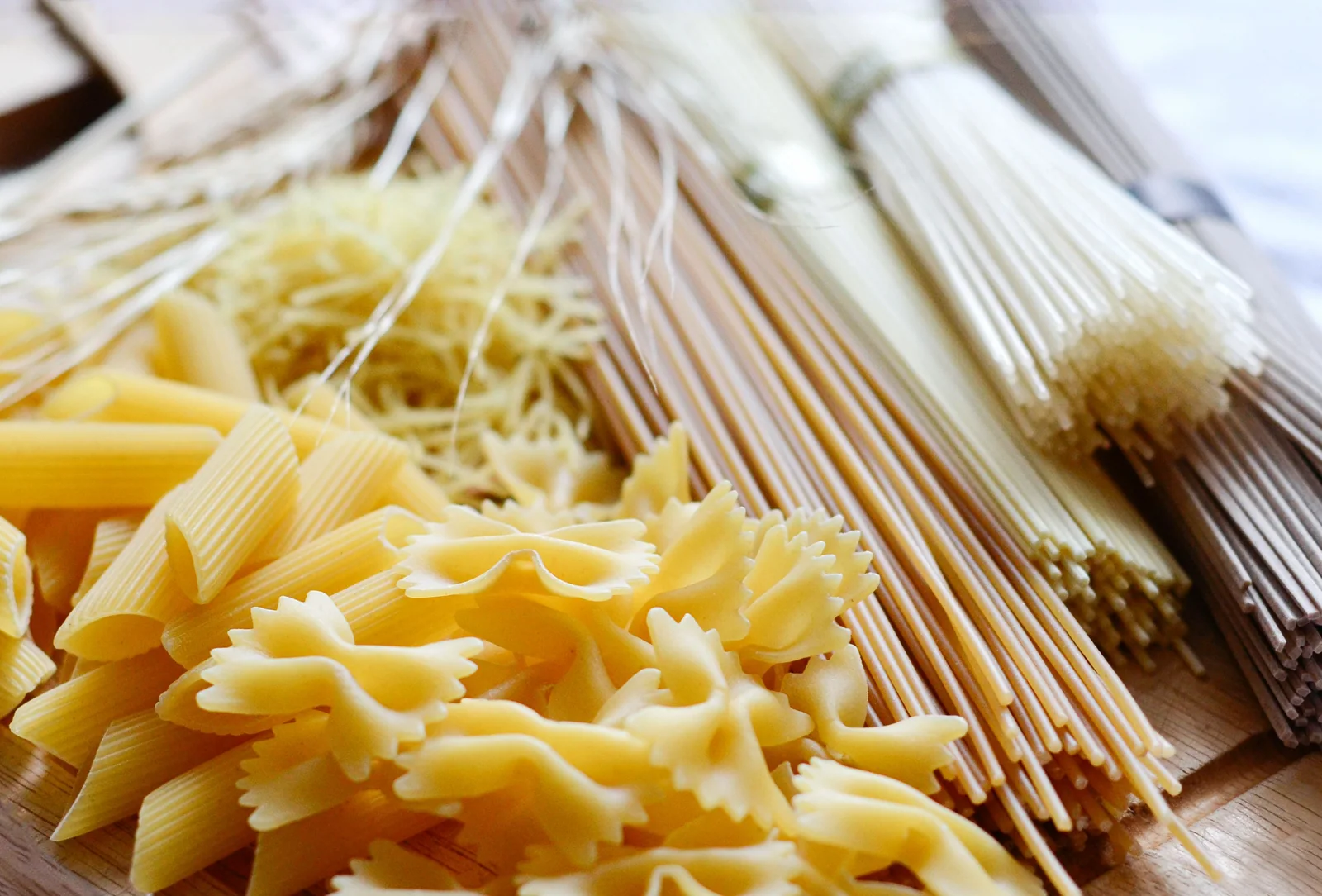 A photograph of assorted long strands, ribbons, tubes and farfalle