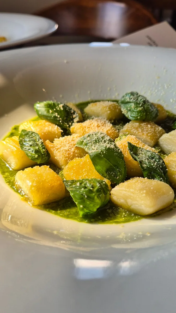 Mahina's potato gnocchi with sauce and basil leaves