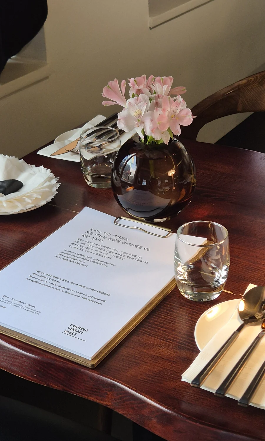 A Mahina table with flowers and a menu
