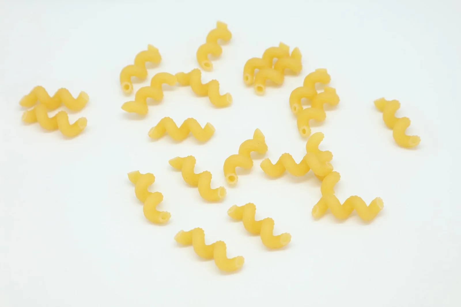 Dried cellentani with hollow tubes curled into spirals