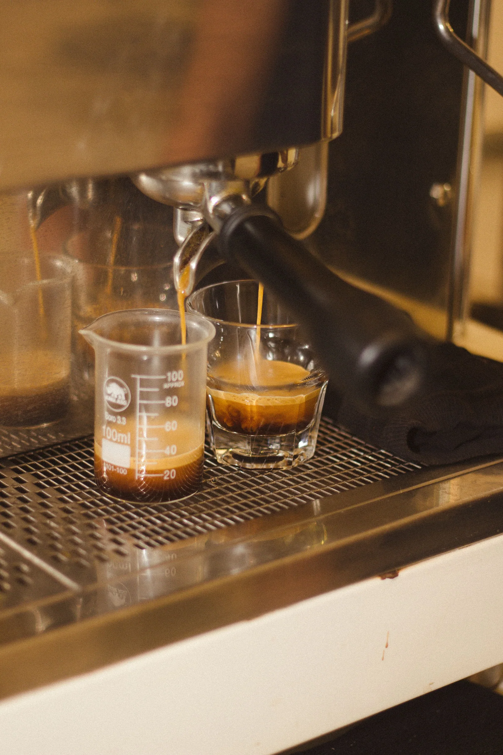 Espresso flowing from the two spouts of a portafilter